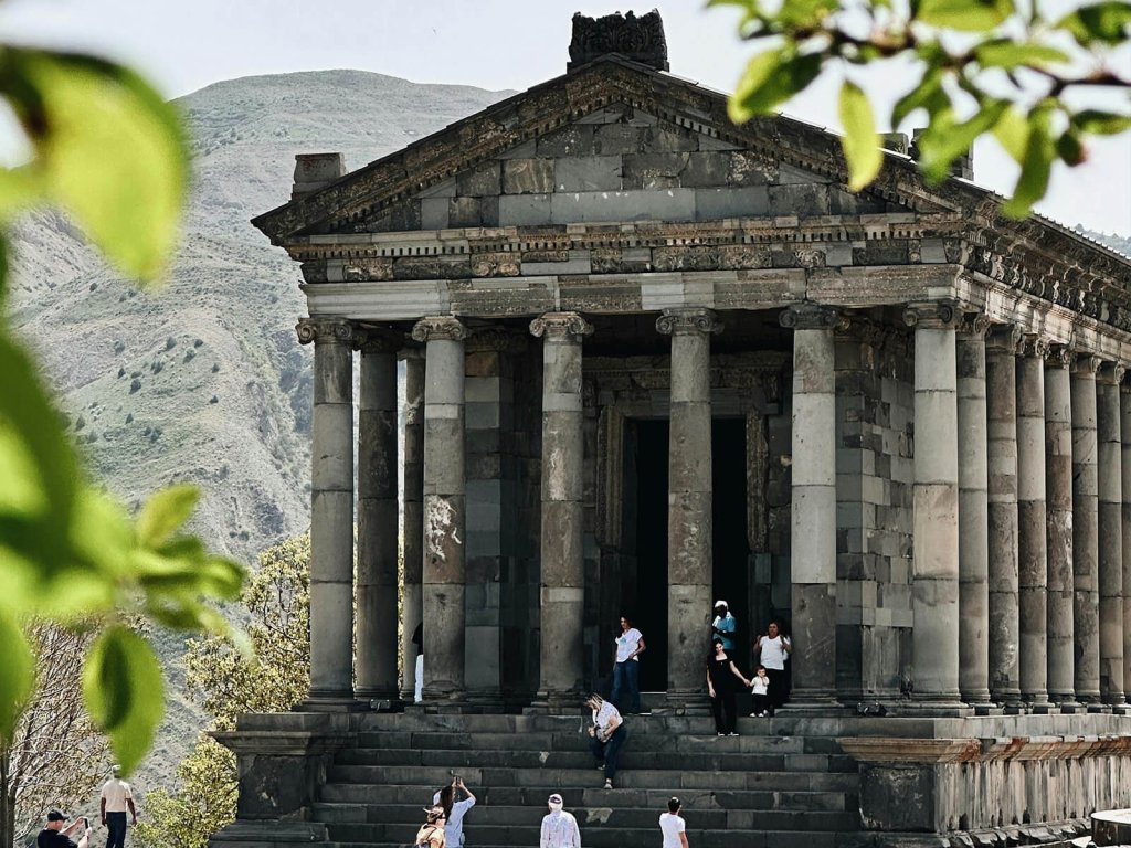 Visitors touring the Temple of Garni in Armenia, a popular historical and cultural site